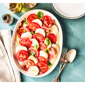 Mozzarella tomatoes and salad with dressing or vinger